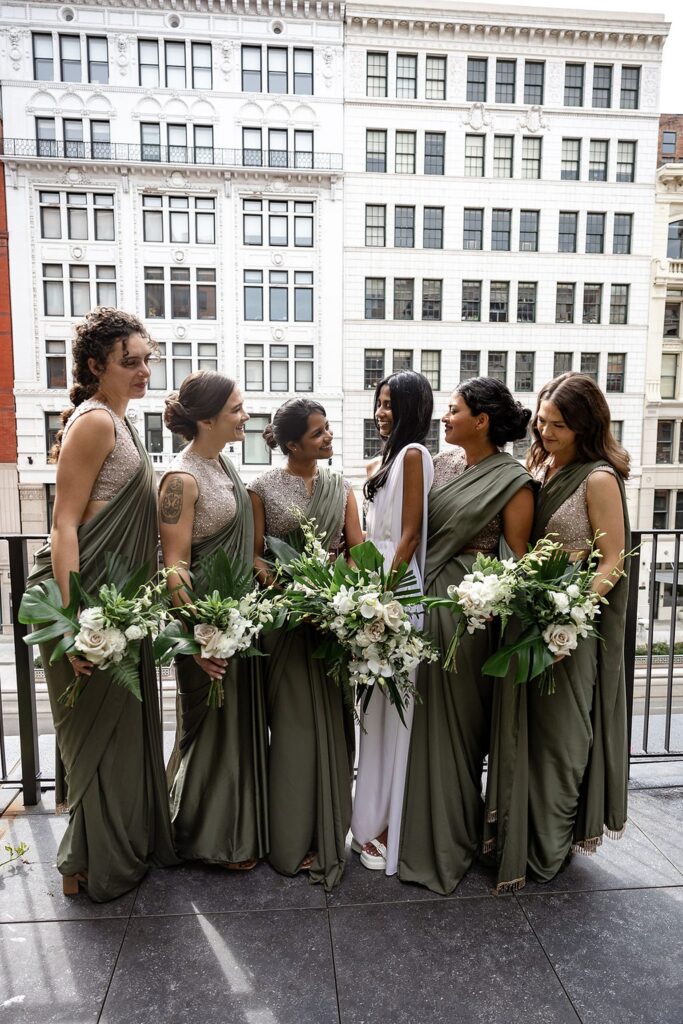 Outdoor balcony bride and bridesmaids portraits at Shinola Hotel in Detroit, MI