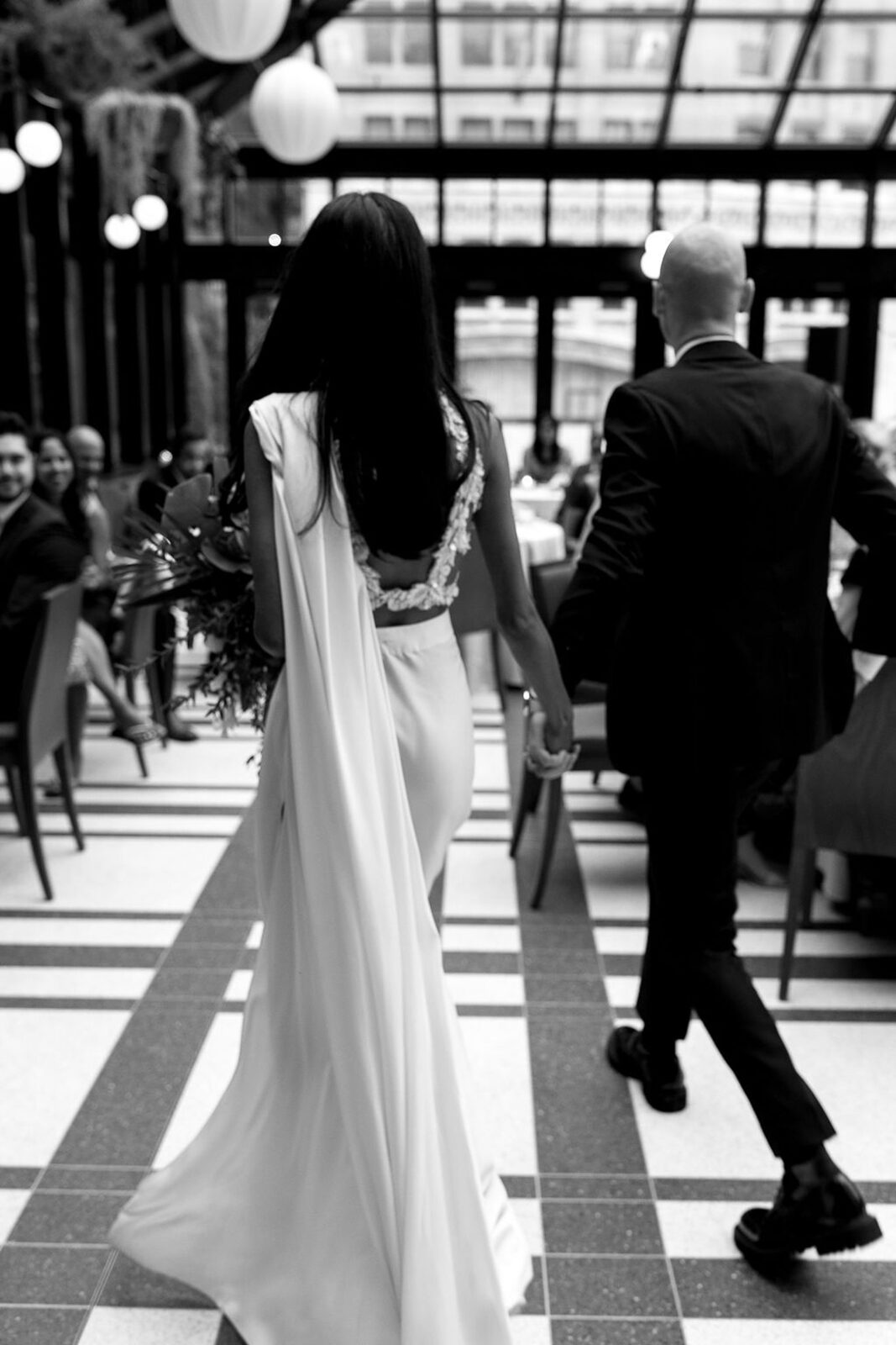 Bride and groom entering their Shinola Hotel wedding reception in The Birdy Room