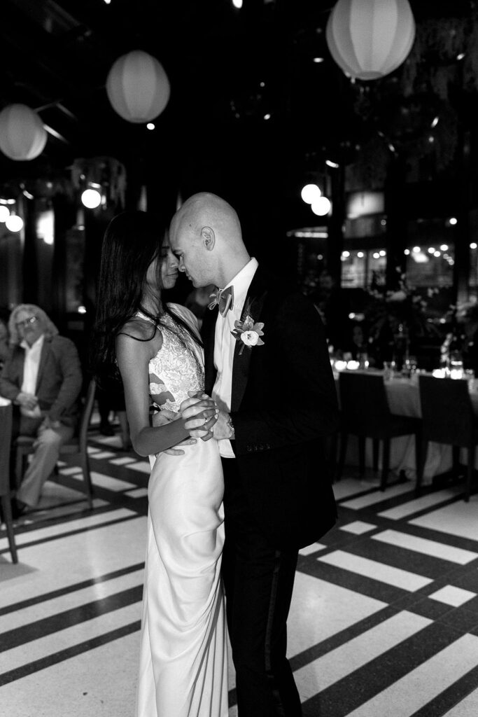 Black and white photo of a bride and groom dancing during their Shinola Hotel wedding reception in The Birdy Room