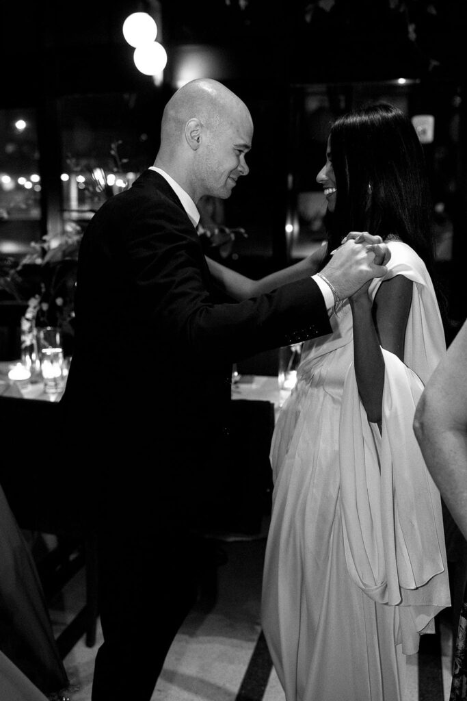 Black and white photo of a bride and groom dancing during their Shinola Hotel wedding reception in The Birdy Room