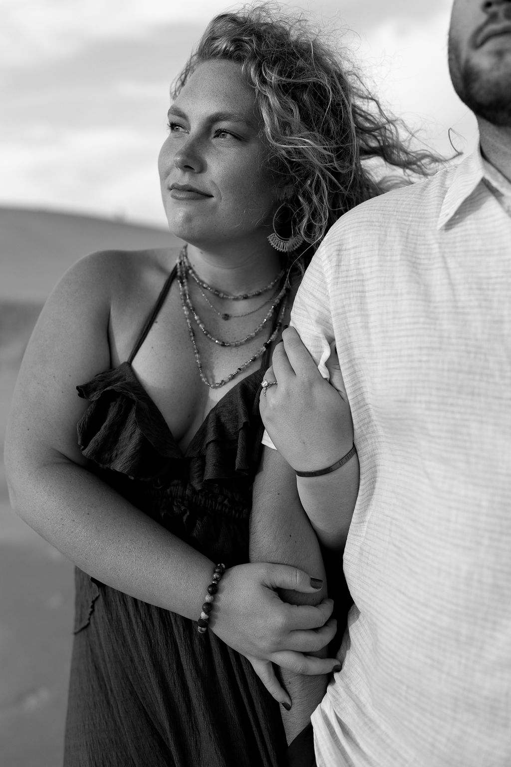 Black and white photo of a couple posing on the beach