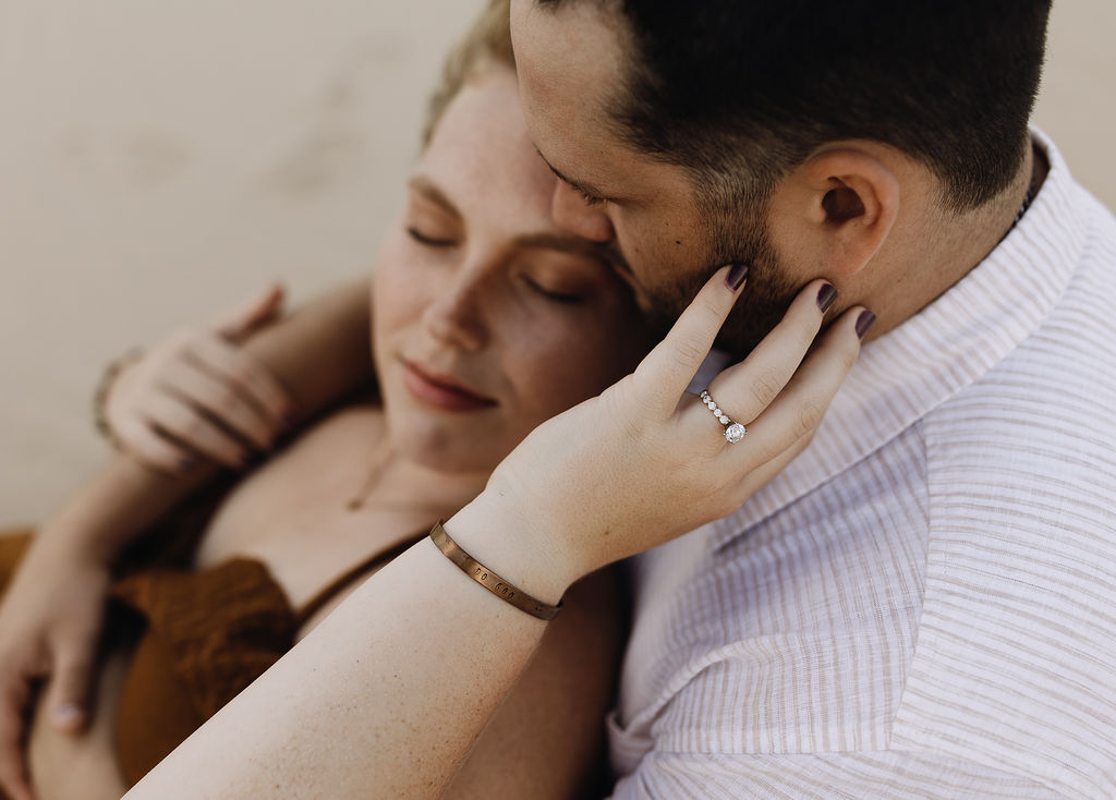 Couple cuddling together on the beach