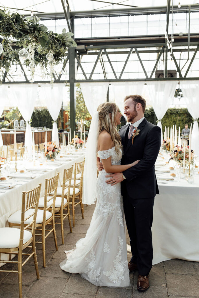 Bride and groom posing at Planterra Conservatory wedding venue in West Bloomfield Township MI