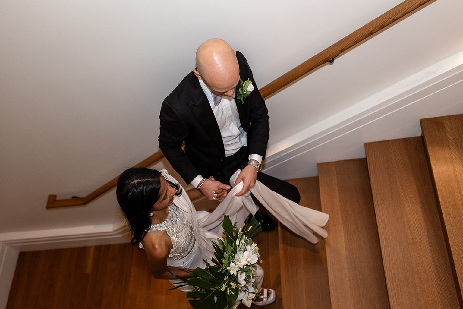 Bride and groom walking up the stairs