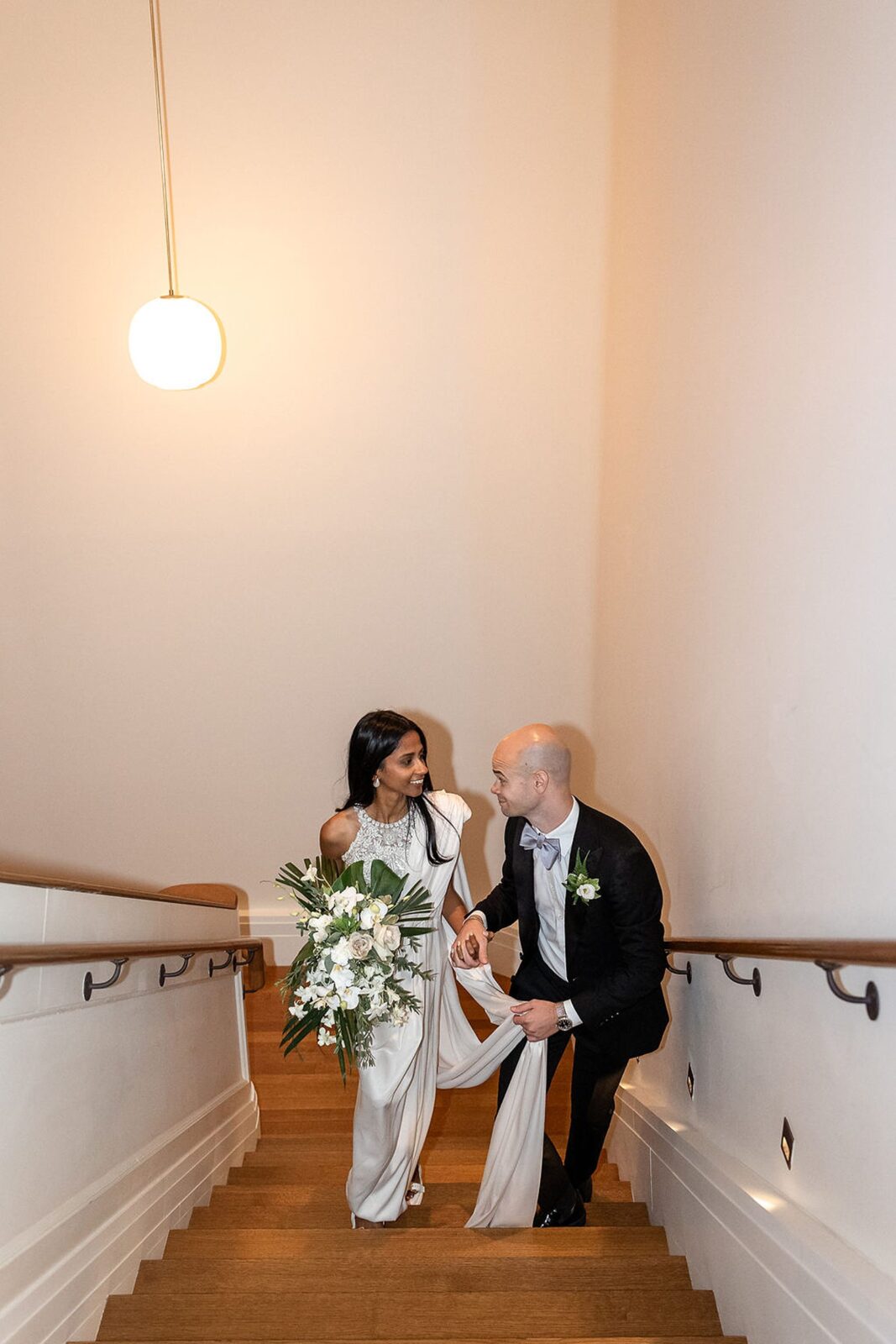 Bride and groom walking up the stairs