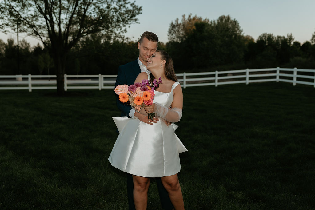 Bride and groom posing on the property of Venue Bella Giornata