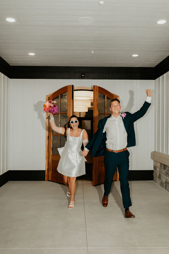 Bride and groom entering their wedding reception with flash photos