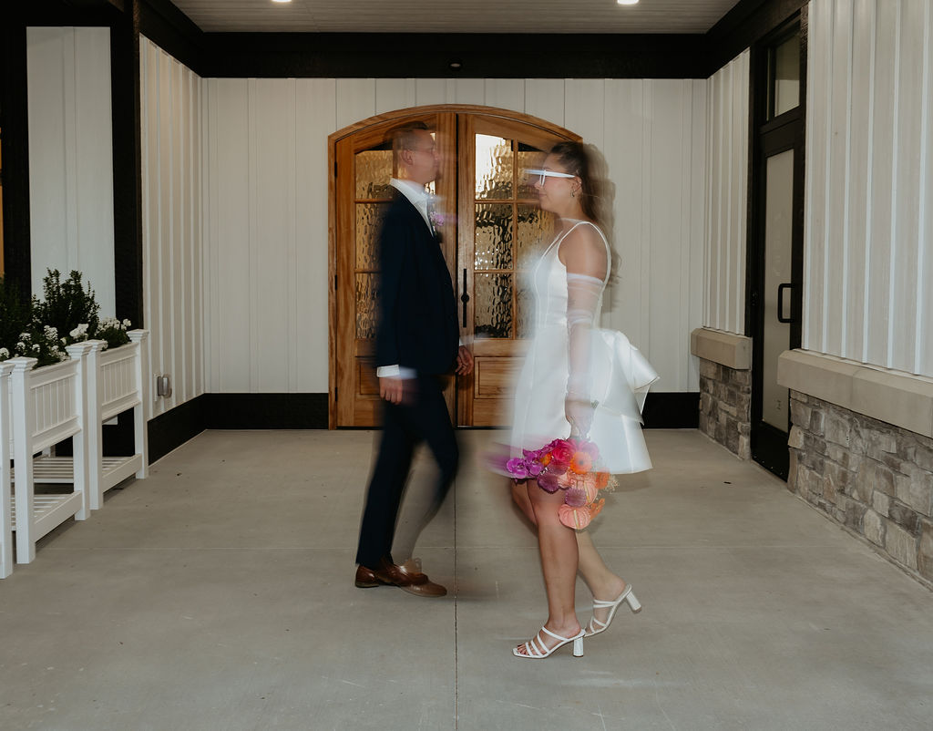 Motion shot of a bride and groom walking at Venue Bella Giornata