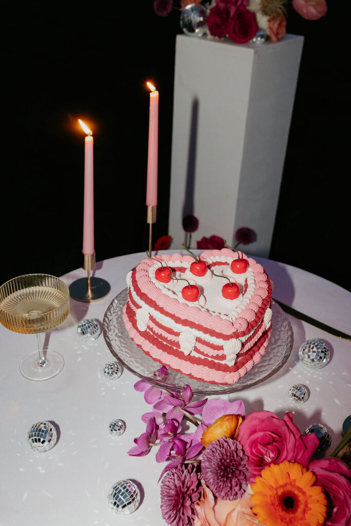 Wedding reception cake table with flowers and champagne