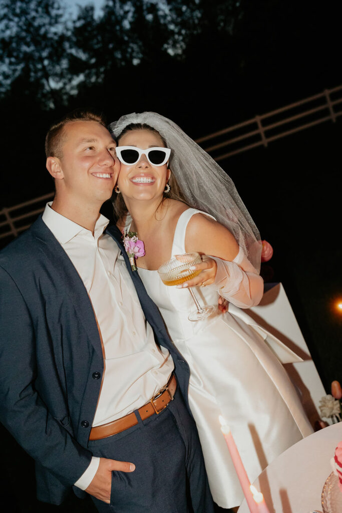 Bride and groom posing for their wedding reception flash photos