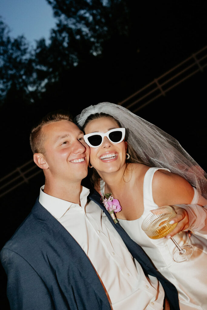 Bride and groom posing for their wedding reception flash photos