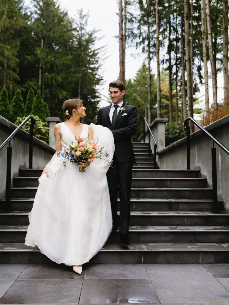 Luxury wedding couple walking down elegant stairs at Shepherd’s Hollow, photographed in editorial and documentary style