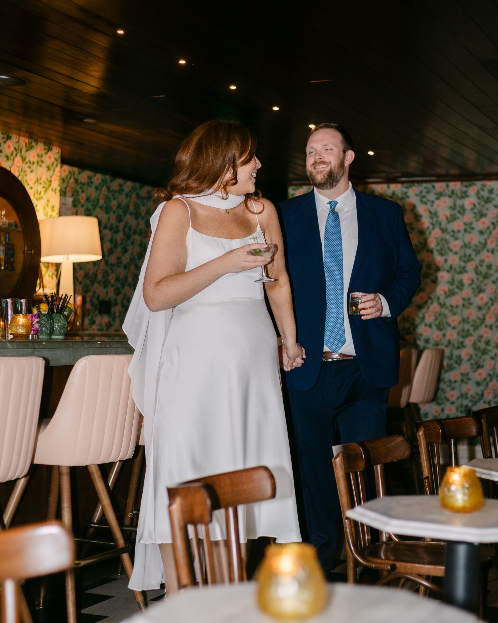 Couple moving loosely through Time Will Tell Detroit bar during engagement session — loose editorial documentary photography by LoHi Images